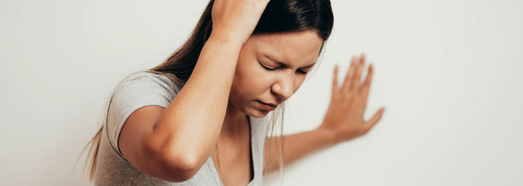 Woman hand to head headache dizzy
