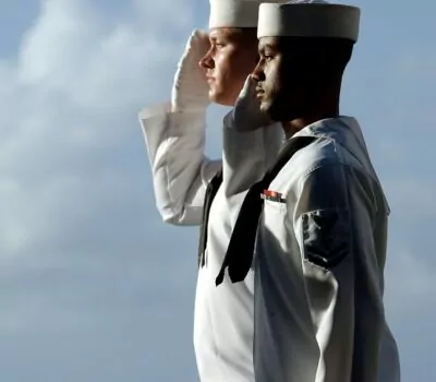 Two men in sailor uniforms at attention