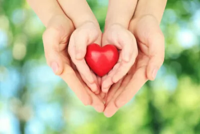 hands clasping heart