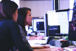 Two women working at a computer