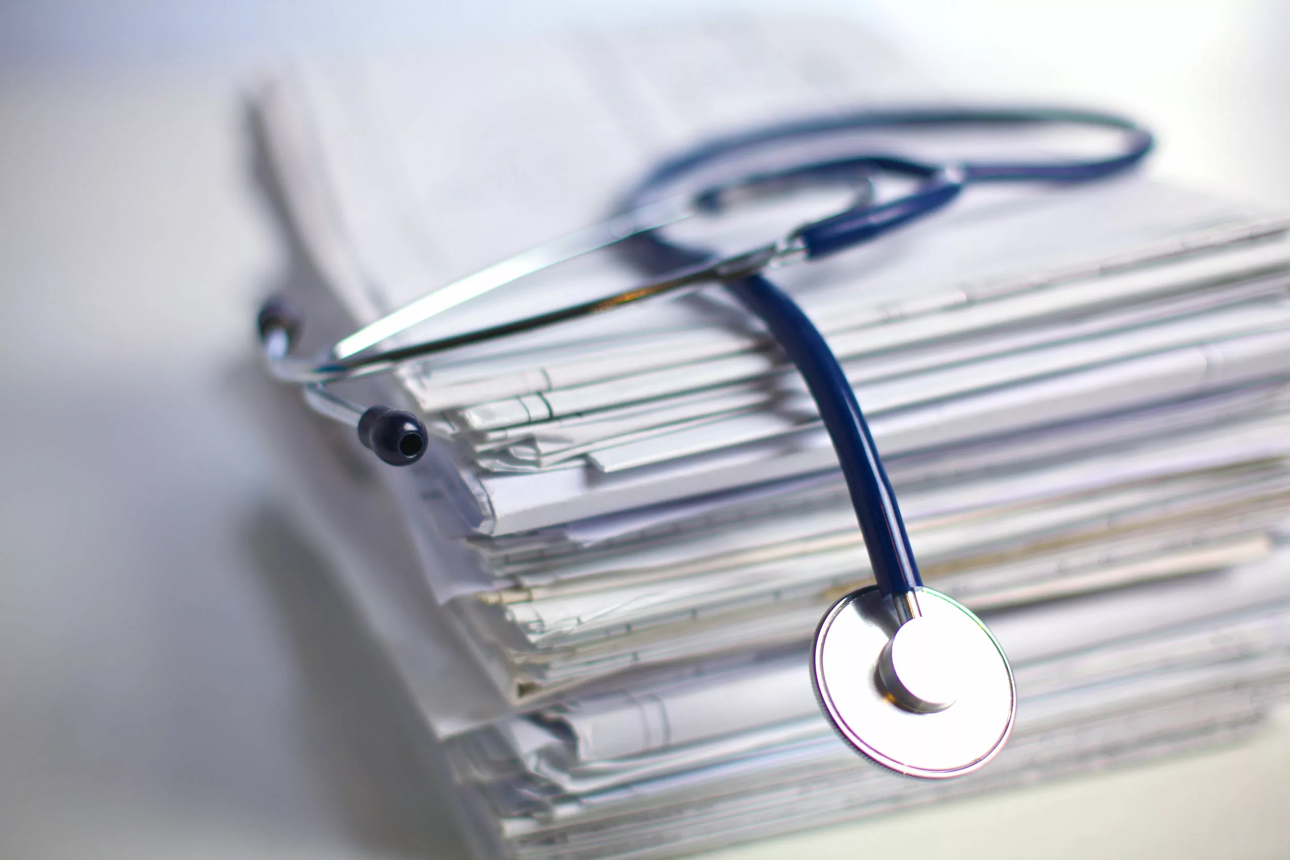 Books, folder file, and stethoscope.